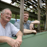 Tom and Vince Mendenhall, father-and-son owners of Arlington, Wash.-based Historic Railway Restoration, inside a  Turtleback streetcar that once operated on Tacoma streets. (PHOTO BY TODD MATTHEWS)