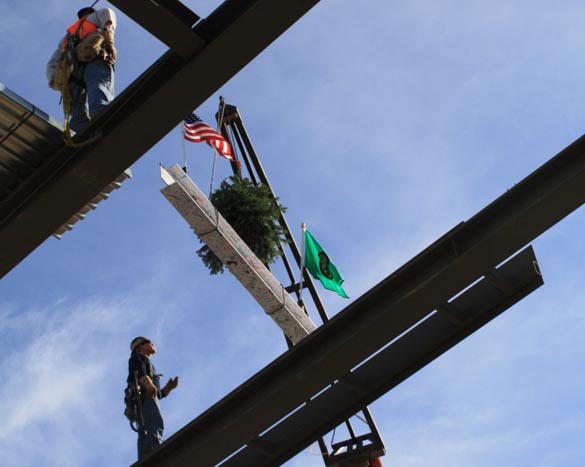 With a drum roll and roaring applause, Tacoma Art Museum raised the final steel beam into place Wednesday afternoon for its building expansion as part of the upcoming Haub Family Galleries. As is building tradition, the beam, signed by supporters of the museum and community members, was adorned with a tree and American and Washington State flags and then lifted high into the web of steel structures that have taken shape on Pacific Avenue. (PHOTO COURTESY TACOMA ART MUSEUM)