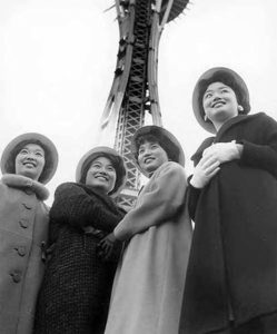 Japanese American Seafair royalty pose in front of the Space Needle, still under construction, in Seattle on Nov. 18, 1961. (ELMER OGAWA PHOTOGRAPH / COURTESY UNIVERSITY OF WASHINGTON LIBRARIES SPECIAL COLLECTIONS)