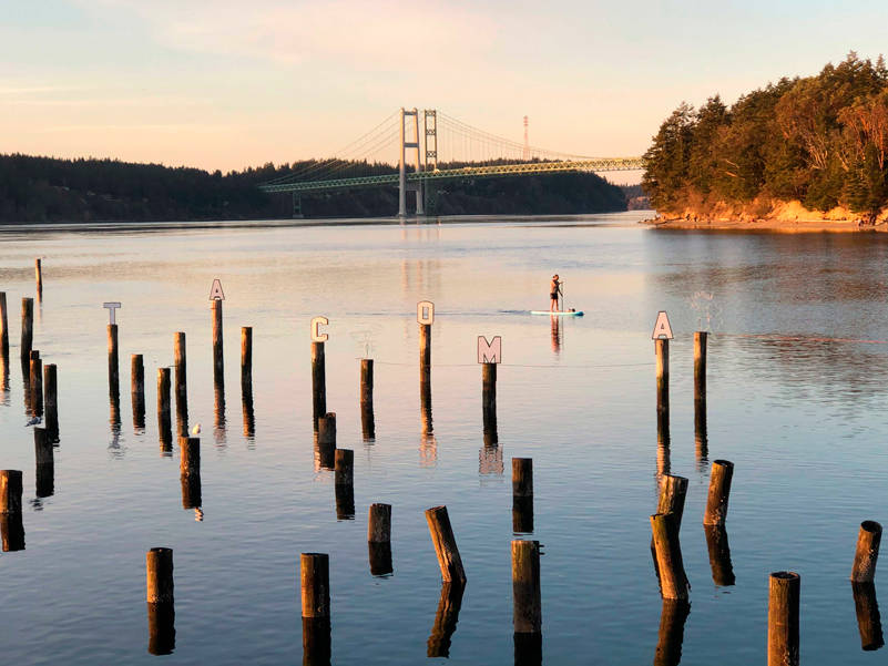 This photo captures a hint of the history, beauty, art and activities available in this local park. Be sure to notice “Tacoma” cleverly spelled out on the historic pilings that were part of the landing for the 6th Avenue Ferry that ran before the Narrows Bridge was built/rebuilt. (Photo by Morf Morford)