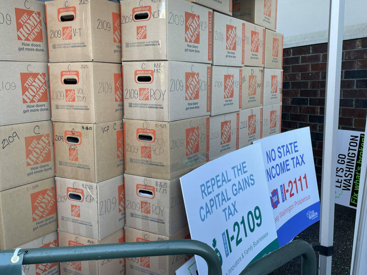 Jerry Cornfield/Washington State Standard
Let’s Go Washington, a political committee, faces allegations it did not properly disclose information on money raised and spent in its signature-gathering drives for six initiatives in 2023. These boxes contain signed petitions for one of them, Initiative 2109, which would to repeal Washington state’s capital gains tax. It will be on ballots in November 2024.