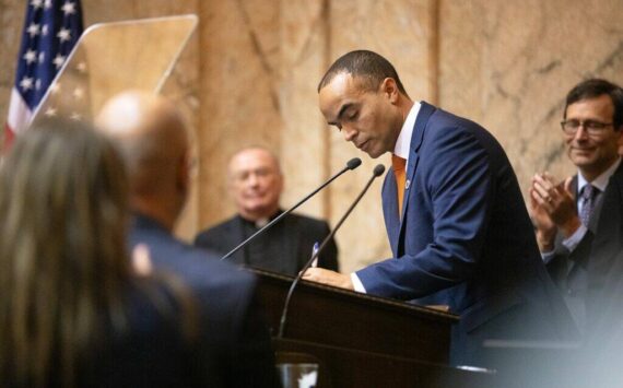 Attorney General Nick Brown signs his election certificate after being sworn in Wednesday, Jan. 15, 2025, at the Washington State Capitol in Olympia, Wash. (Ryan Berry/Washington State Standard)